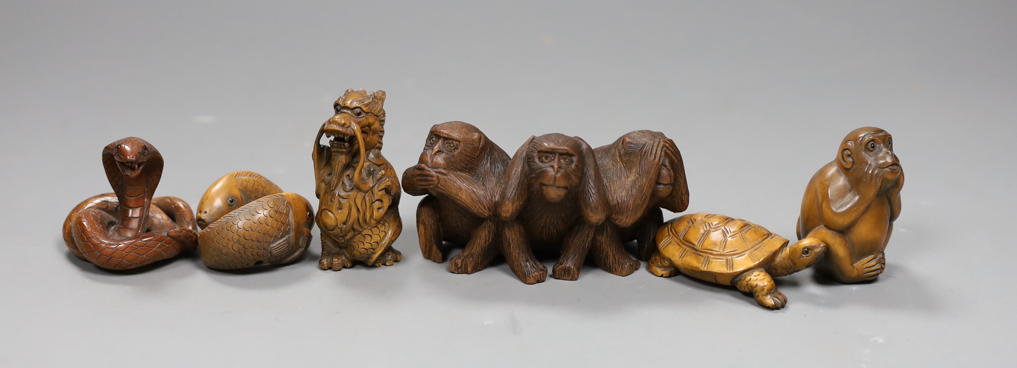 Five wooden animal netsuke; koi, cobra, monkey, tortoise, hear no, see no, say no monkey group, together with a carved wooden figure of a dragon, tallest 5cm